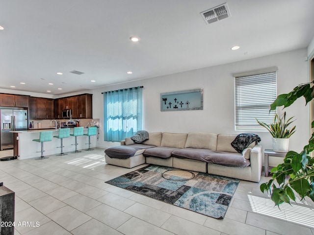 tiled living room featuring a wealth of natural light