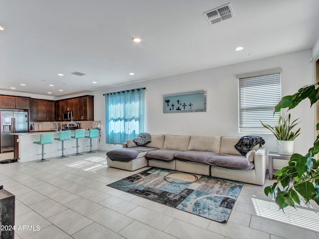 living area with visible vents, recessed lighting, and light tile patterned floors