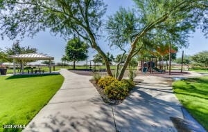 view of community with a playground and a lawn