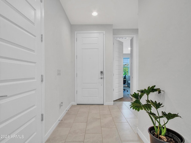 entrance foyer with light tile patterned floors and baseboards