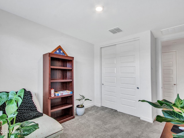 bedroom featuring a closet and light colored carpet