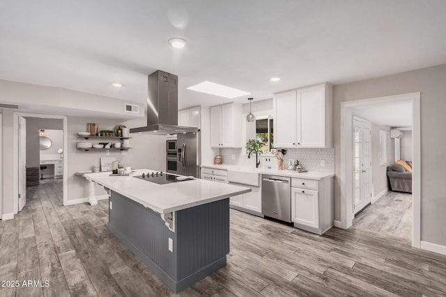 kitchen with island exhaust hood, open shelves, backsplash, appliances with stainless steel finishes, and white cabinets