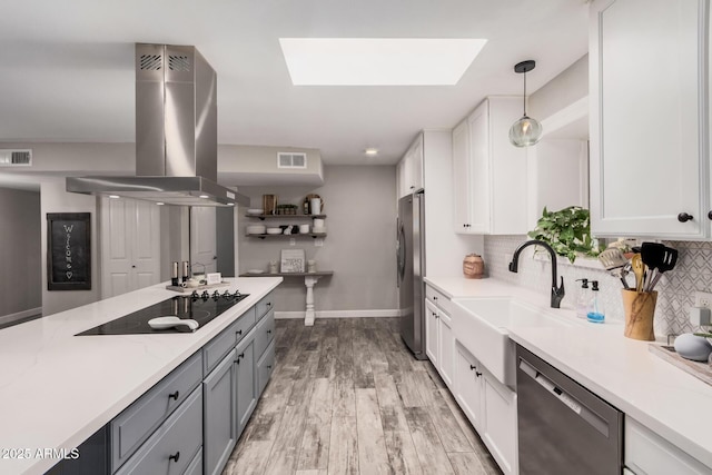 kitchen with visible vents, white cabinets, appliances with stainless steel finishes, and island exhaust hood