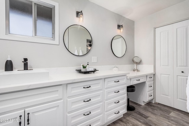 bathroom with vanity and wood finished floors