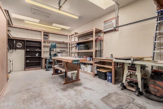 interior space featuring a workshop area and an AC wall unit