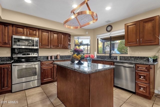 15011 N 45th Pl, Phoenix, AZ 85032 - kitchen featuring sink, a center island, light tile patterned floors, dark stone countertops, and stainless steel appliances