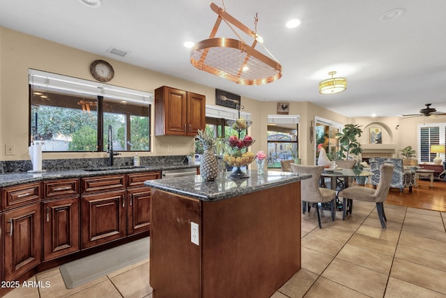 15011 N 45th Pl, Phoenix, AZ 85032 - kitchen featuring sink, a center island, light tile patterned floors, ceiling fan, and dark stone counters