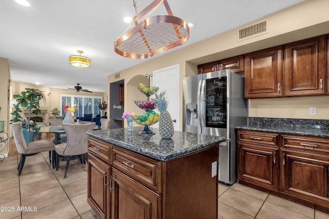 15011 N 45th Pl, Phoenix, AZ 85032 - kitchen featuring light tile patterned flooring, stainless steel fridge, a kitchen island, and dark stone countertops