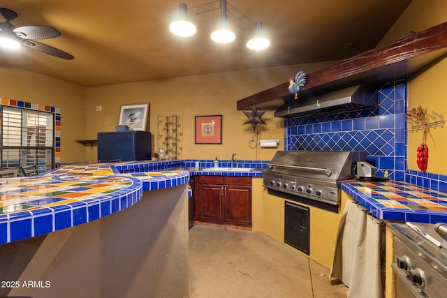 15011 N 45th Pl, Phoenix, AZ 85032 - kitchen with sink, ceiling fan, tile counters, decorative backsplash, and wall chimney exhaust hood