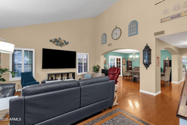 15011 N 45th Pl, Phoenix, AZ 85032 - living room featuring wood-type flooring, high vaulted ceiling, and a chandelier