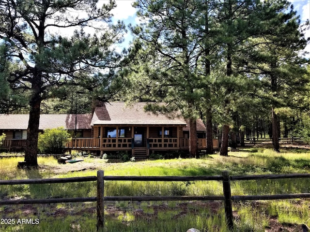 12814 E Dream Acres Ln, Parks, AZ 86018 - back of house with roof with shingles, log exterior, and covered porch