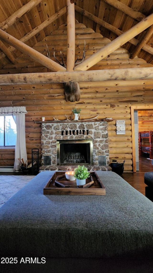 12814 E Dream Acres Ln, Parks, AZ 86018 - living room with log walls, high vaulted ceiling, wood ceiling with exposed beams, a stone fireplace, and wood finished floors