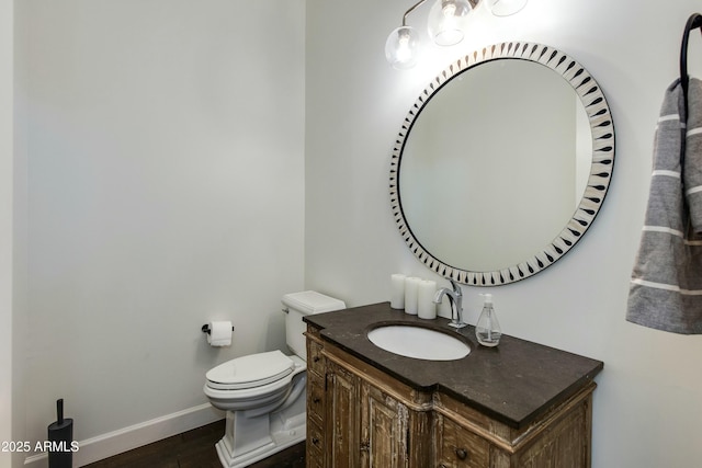 bathroom with hardwood / wood-style floors, vanity, and toilet