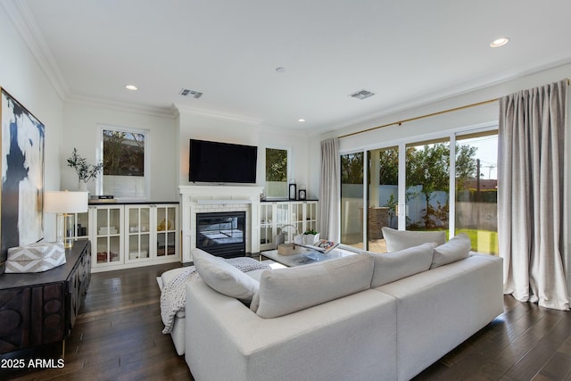 living room with crown molding and dark wood-type flooring