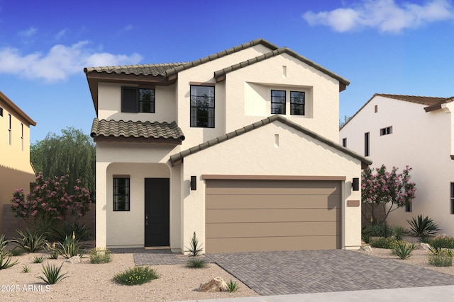 mediterranean / spanish home with a tiled roof, decorative driveway, a garage, and stucco siding