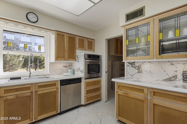 kitchen featuring appliances with stainless steel finishes, backsplash, and sink