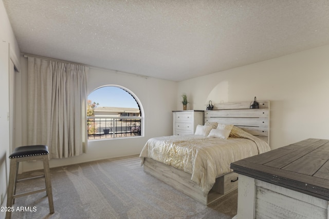 bedroom with a textured ceiling and carpet floors