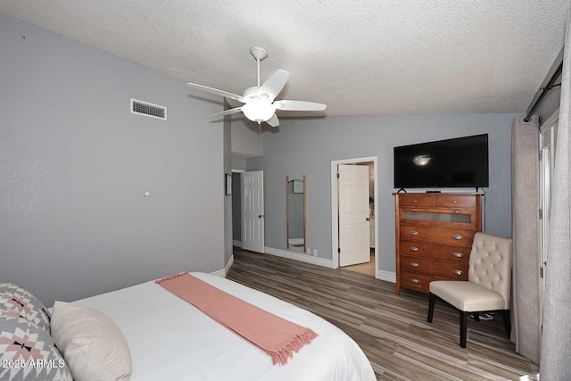 4609 E Monte Cristo Ave, Phoenix, AZ 85032 - bedroom with wood finished floors, vaulted ceiling, a textured ceiling, baseboards, and ceiling fan