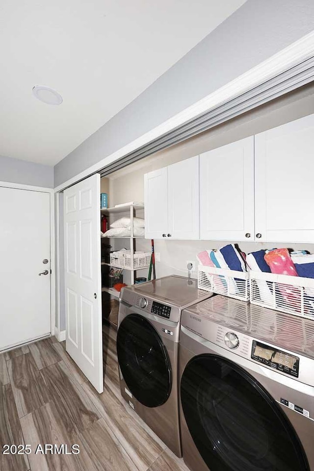 4609 E Monte Cristo Ave, Phoenix, AZ 85032 - laundry area with cabinet space, washer and clothes dryer, and light wood-style flooring