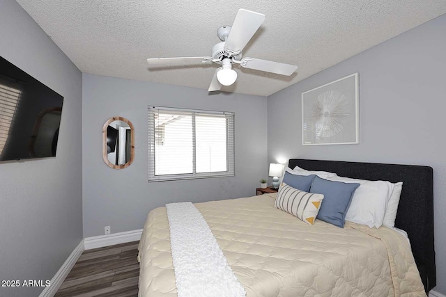 4609 E Monte Cristo Ave, Phoenix, AZ 85032 - bedroom with wood finished floors, a textured ceiling, baseboards, and a ceiling fan