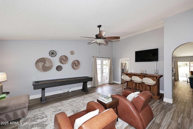 4609 E Monte Cristo Ave, Phoenix, AZ 85032 - living room with a ceiling fan, a textured ceiling, wood finished floors, arched walkways, and vaulted ceiling