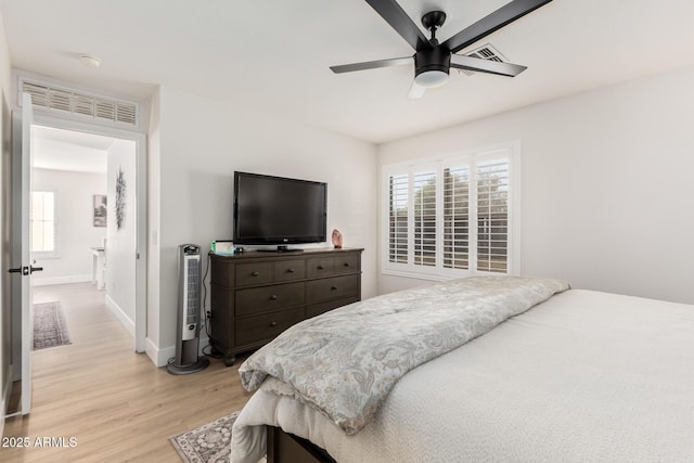 bedroom with light wood-type flooring, baseboards, visible vents, and ceiling fan