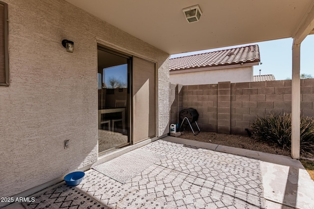 view of patio featuring fence