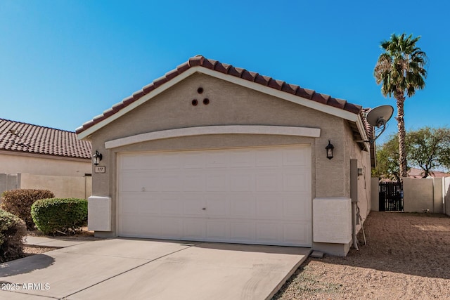 garage with driveway and fence