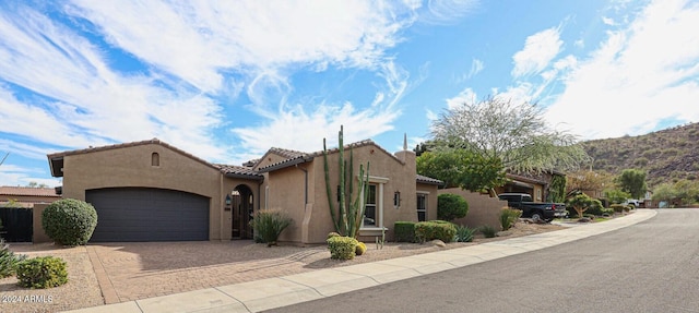 view of front of home featuring a mountain view and a garage