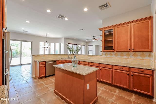 kitchen with dishwasher, a center island, backsplash, kitchen peninsula, and pendant lighting