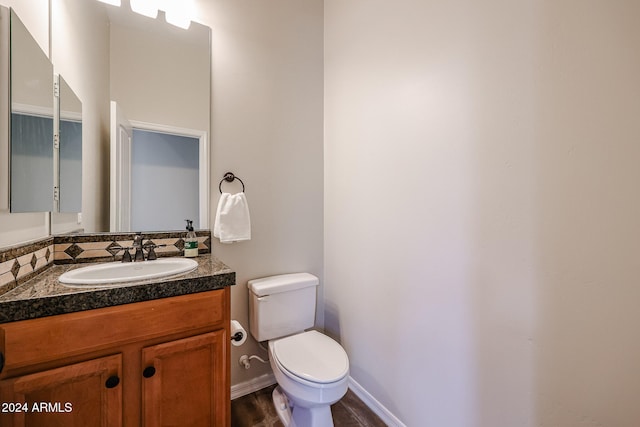 bathroom featuring hardwood / wood-style floors, vanity, and toilet