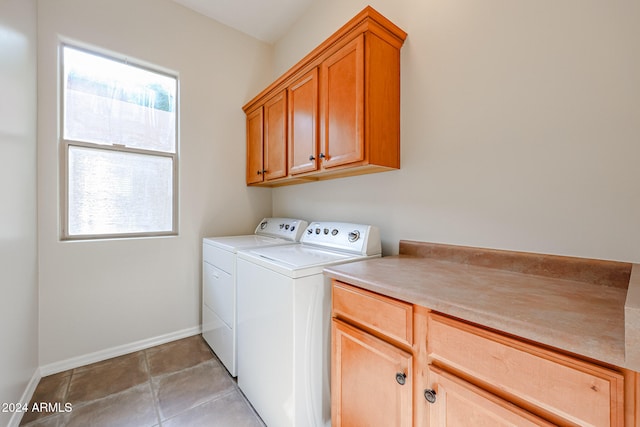 washroom with cabinets, independent washer and dryer, and light tile patterned floors