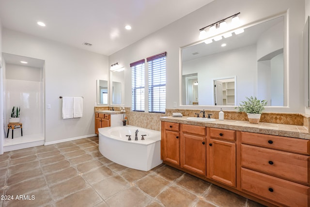 bathroom with vanity, a tub to relax in, and tile patterned floors