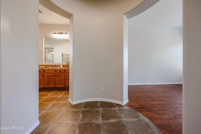 hallway featuring wood-type flooring and sink