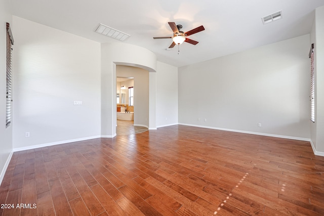 spare room featuring ceiling fan and dark wood-type flooring