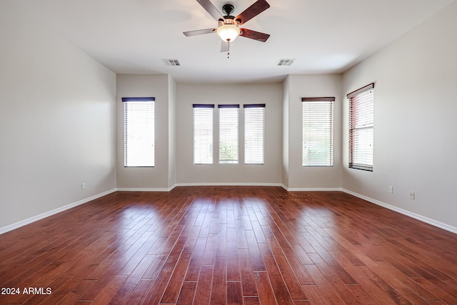 unfurnished room with dark hardwood / wood-style floors and ceiling fan