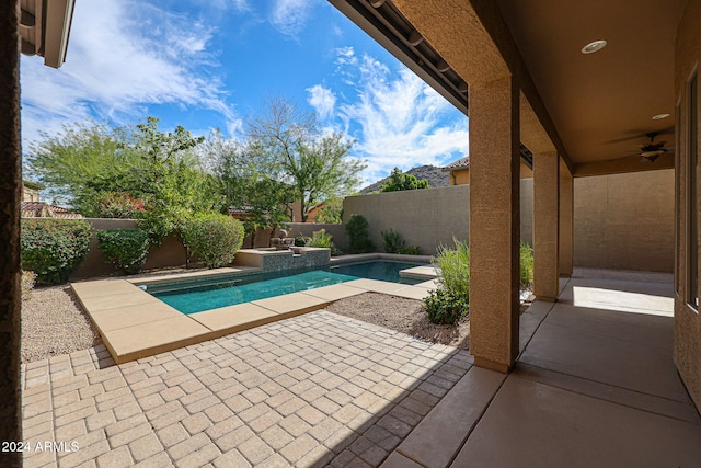 view of pool with a patio area, ceiling fan, and an in ground hot tub