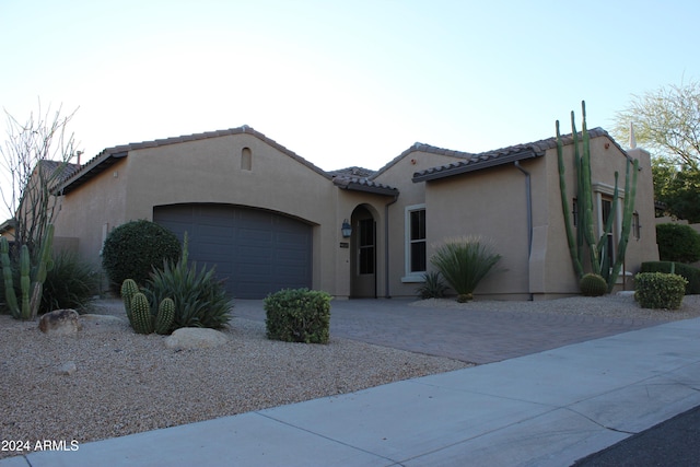 mediterranean / spanish-style house featuring a garage