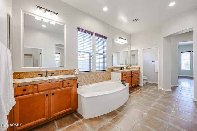 25995 N 85th Dr, Peoria, AZ 85383 - full bath with a garden tub, toilet, two vanities, recessed lighting, and tile patterned floors
