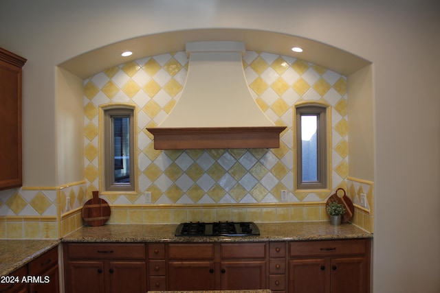 25995 N 85th Dr, Peoria, AZ 85383 - kitchen with black gas stovetop, custom exhaust hood, tasteful backsplash, and stone counters