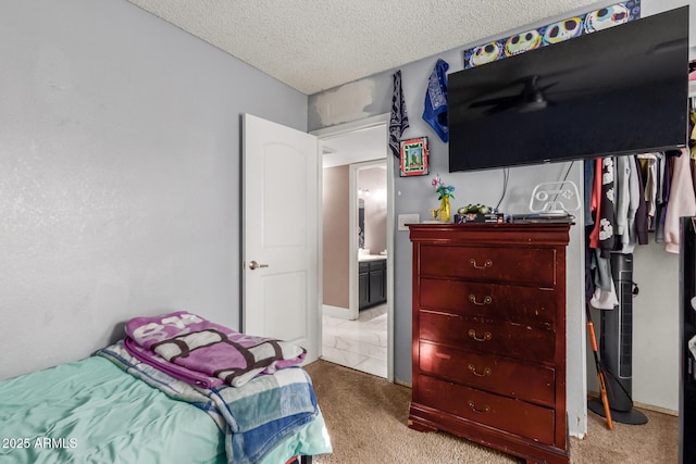 bedroom featuring light colored carpet and a textured ceiling