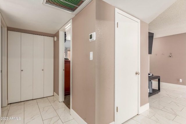 hallway featuring a textured ceiling