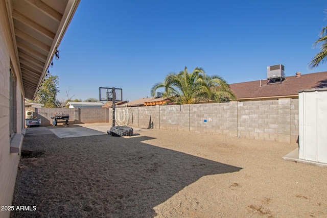 view of yard with a patio and central AC unit