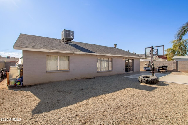 rear view of house with a patio and central AC