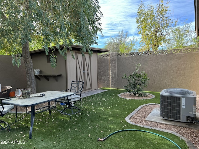 5839 E Norwood St, Mesa, AZ 85215 - view of yard featuring an outbuilding, a shed, a fenced backyard, and central AC unit