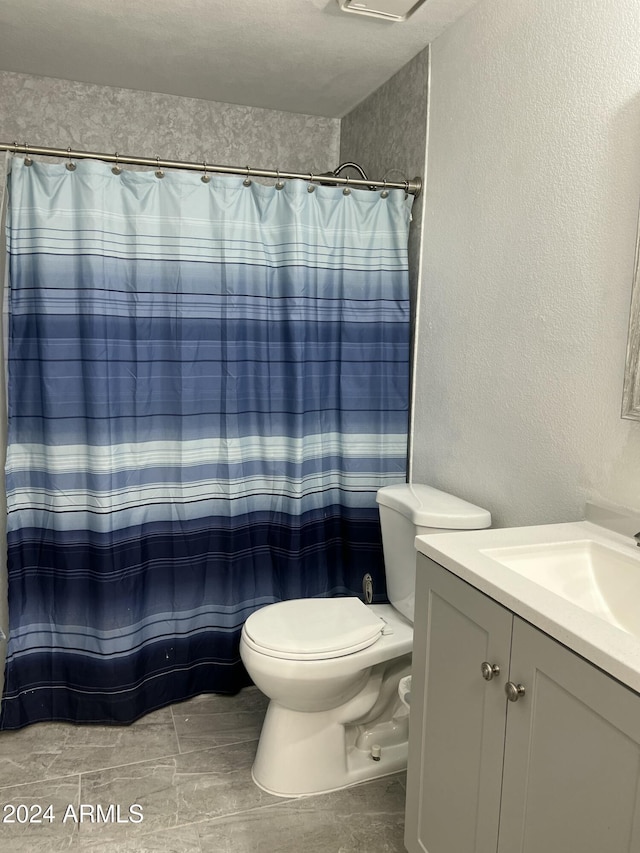 5839 E Norwood St, Mesa, AZ 85215 - bathroom featuring curtained shower, toilet, a textured wall, and vanity