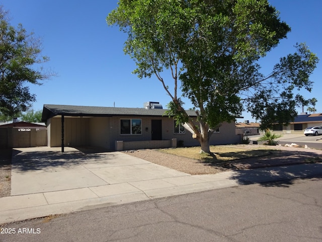 3171 W Orchid Ln, Phoenix, AZ 85051 - view of front of home featuring driveway, brick siding, and a carport