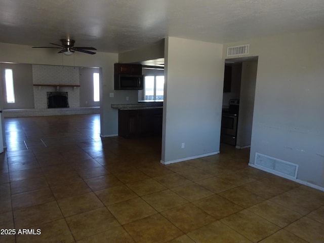 3171 W Orchid Ln, Phoenix, AZ 85051 - unfurnished living room featuring ceiling fan, baseboards, a brick fireplace, and tile patterned flooring