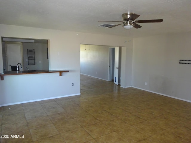 3171 W Orchid Ln, Phoenix, AZ 85051 - empty room with a ceiling fan, baseboards, and a sink