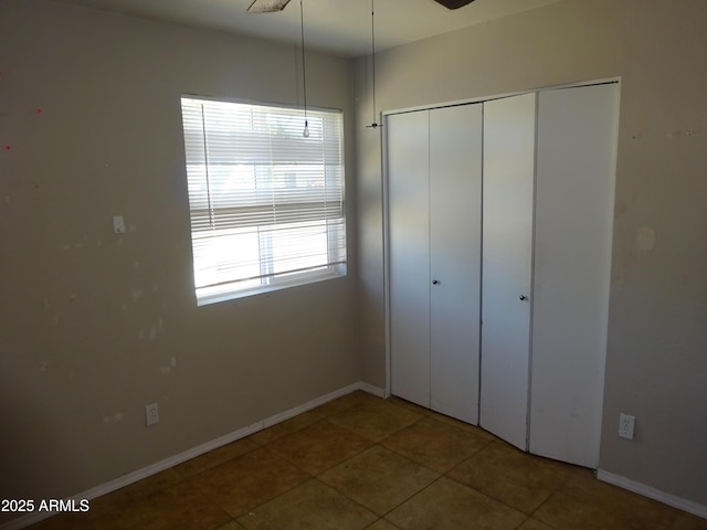 3171 W Orchid Ln, Phoenix, AZ 85051 - unfurnished bedroom featuring a closet, tile patterned floors, and baseboards